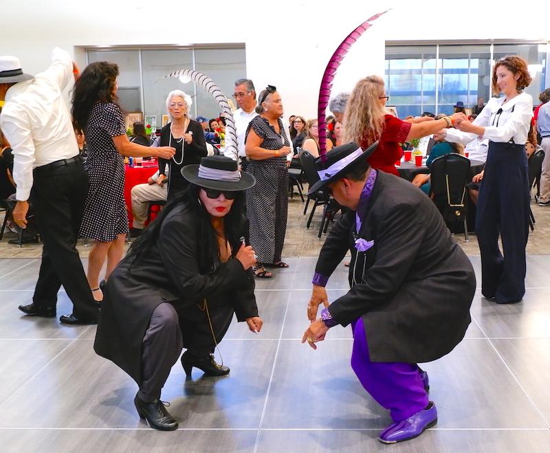 photo from an Annual Pachuco Ball with people dressed up dancing